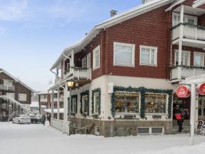 a building with a store in the snow at Holiday Home Keskuskuja b4 by Interhome in Sirkka