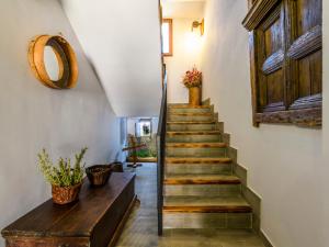 a stairway with wooden stairs and a wooden table at Apartment El Ventanico by Interhome in Olocau del Rey