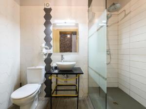 a bathroom with a white toilet and a sink at Apartment El Ventanico by Interhome in Olocau del Rey