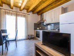 a kitchen with a large flat screen tv at Apartment El Ventanico by Interhome in Olocau del Rey