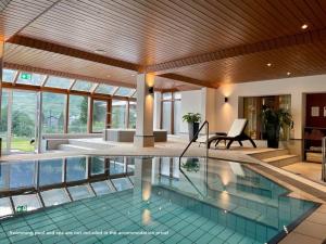 a swimming pool in the middle of a house at Hubertus 112 in Obergesteln