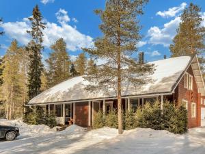 una casa di mattoni rossi con un tetto d'argento nella neve di Holiday Home Villa hanhi by Interhome a Rovaniemi