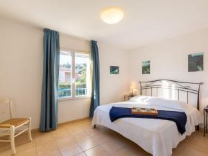 a bedroom with a bed and a window at Holiday Home Le Mas d'Esquières 16 by Interhome in Les Issambres