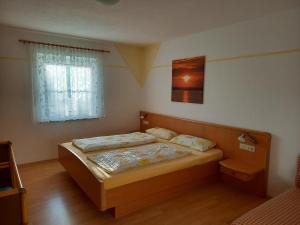 Ένα ή περισσότερα κρεβάτια σε δωμάτιο στο Ferienhof Metzler