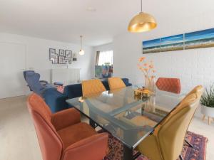 a living room with a glass table and chairs at Holiday Home Klemskerkestraat by Interhome in Bredene