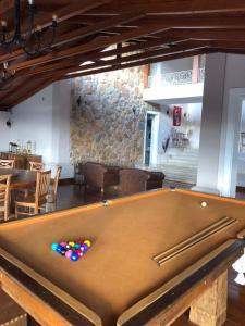 a pool table with balls on it in a room at Pousada Pedra Pimenta in Tiradentes