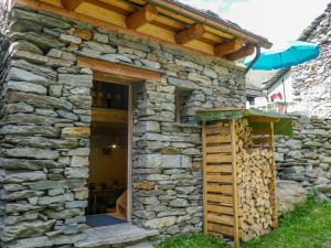 a stone house with a wooden roof at Holiday Home Rustico La Dimora by Interhome in Malvaglia