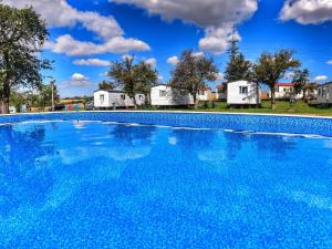 a large swimming pool with houses in the background at Holiday Home Prima by Interhome in Prague