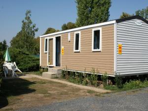 a small house with a table and a tent at Holiday Home Camping Sokol by Interhome in Prague