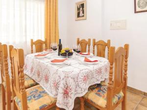 a dining room table with a white and red table cloth at Holiday Home Las Tijeras by Interhome in Rute