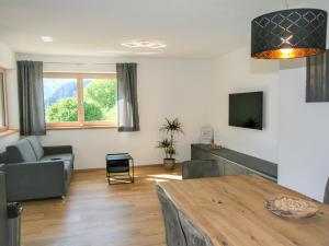 a living room with a couch and a table at Apartment Apartment Georg by Interhome in Kaltenbach