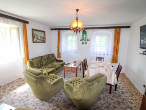 a living room with a couch and a table and chairs at Holiday Home Vlhlavy u Hluboké by Interhome in Sedlec