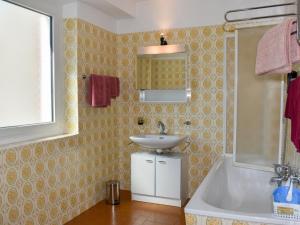 a bathroom with a sink and a bath tub at Apartment Le Bolle by Interhome in Magadino