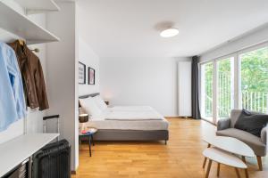 a bedroom with a bed and a living room at BENSIMON apartments Prenzlauer Berg in Berlin
