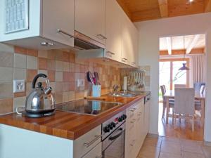 a kitchen with a tea kettle on a counter at Apartment Racer's Retreat Apt-2 by Interhome in Wengen +33 photos