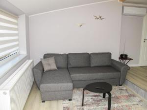 a living room with a couch and a table at Holiday Home Philipp by Interhome in Loissin