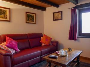 a living room with a brown leather couch and a table at Holiday Home Margarita by Interhome in Prosito