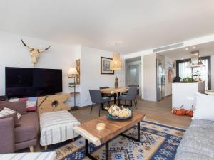 a living room with a couch and a table at Apartment Cala by Interhome in Sant Antoni de Calonge