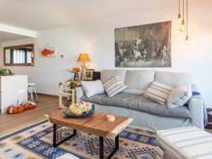 a living room with a couch and a table at Apartment Cala by Interhome in Sant Antoni de Calonge +16 photos