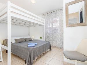 a bedroom with a bed and a loft bed at Apartment Pattaya-10 by Interhome in Empuriabrava
