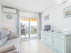 a living room with a couch and a tv at Apartment Pattaya-10 by Interhome in Empuriabrava