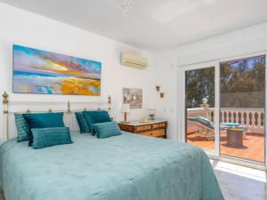 a bedroom with a bed and a large window at Villa Villa Juna-2 in Benalmádena
