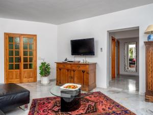 a living room with a tv on a wall at Villa Villa Juna by Interhome in Benalmádena