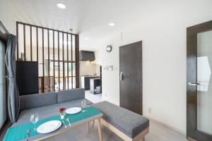 a living room with a couch and a table at Otuska house with 2BR near the Yamanote line in Tokyo