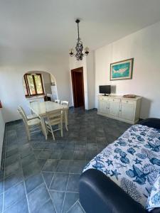 a bedroom with a table and a dining room at Trilo Lu Rattali in San Teodoro