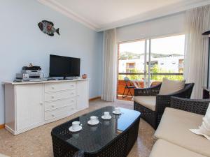 a living room with a couch and a tv at Apartment Brumar by Interhome in Tossa de Mar