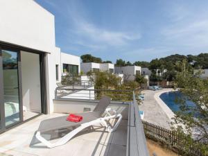 a white chair on the balcony of a house at Holiday Home Brasil by Interhome in Llafranc