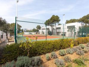 a tennis court with a net on a tennis court at Holiday Home Brasil by Interhome in Llafranc