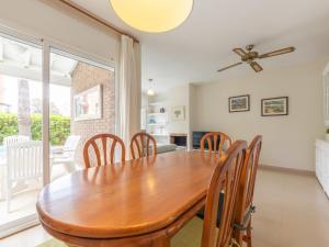 a dining room with a wooden table and chairs at Holiday Home Canyadell by Interhome in Torredembarra