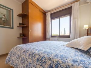 a bedroom with a large bed and a window at Apartment L'Estel by Interhome in Torredembarra
