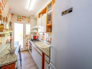 a kitchen with a refrigerator and a sink at Apartment Riumar by Interhome in Segur de Calafell +24 photos