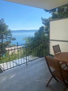 a balcony with a table and a view of the ocean at Villa Amari in Brela