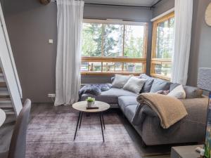 a living room with a couch and a table at Holiday Home Rukaköngäs 21 by Interhome in Ruka