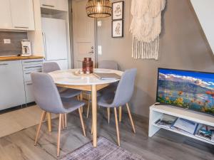 a dining room with a table and chairs and a tv at Holiday Home Rukaköngäs 21 by Interhome in Ruka