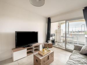 a living room with a large flat screen tv at Apartment Les Héliades-2 by Interhome in Cap d'Agde