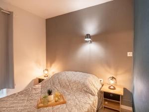 a bedroom with a bed and two lights on the wall at Apartment Les Héliades-2 by Interhome in Cap d'Agde