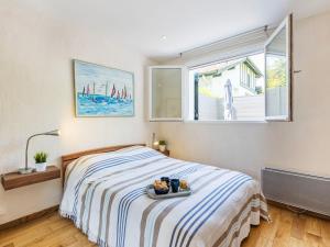 a bedroom with a bed with a tray of food on it at Apartment Jean Jaurès-2 by Interhome in Ciboure