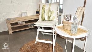a chair sitting in a room with a table at Paradise Sea Terrace in Monopoli