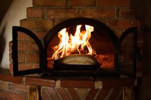 a brick oven with a bread in it at RoVillage România 