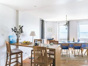 a kitchen and dining room with a table and chairs at Apartment La Vigie by Interhome in Cancale
