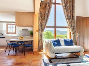 a kitchen and living room with a bed and a table at Holiday Home Le Belvédère by Interhome in La Londe-les-Maures +21 photos