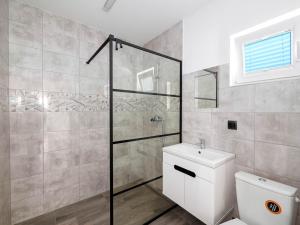 a bathroom with a toilet and a glass shower at Zakatek Baltyku in Jezierzany