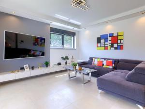 a living room with a couch and a tv at Villa Tara by Interhome in Medulin