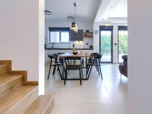 a kitchen and dining room with a table and chairs at Villa Tara by Interhome in Medulin