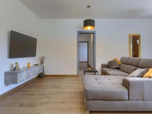 a living room with a couch and a flat screen tv at Apartment Eroa by Interhome in Žminj