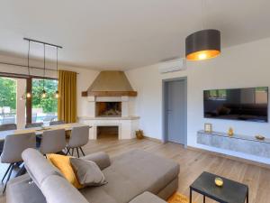 a living room with a couch and a dining room at Apartment Eroa by Interhome in Žminj +35 photos